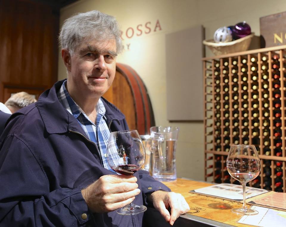 Bill Stoeger with glass of wine